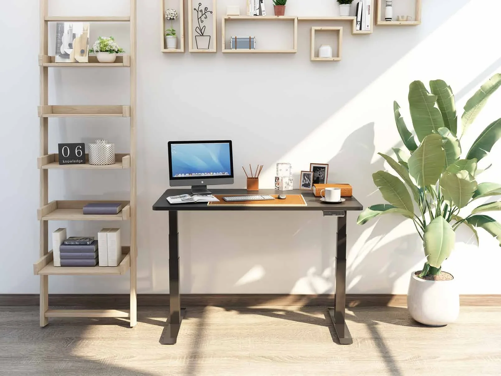 A black-frame desk with a dark top and an iMac in a sunlit room, beside a ladder shelf and a tall plant.